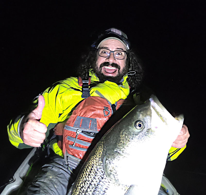 kayak angler alan battista with a big striper