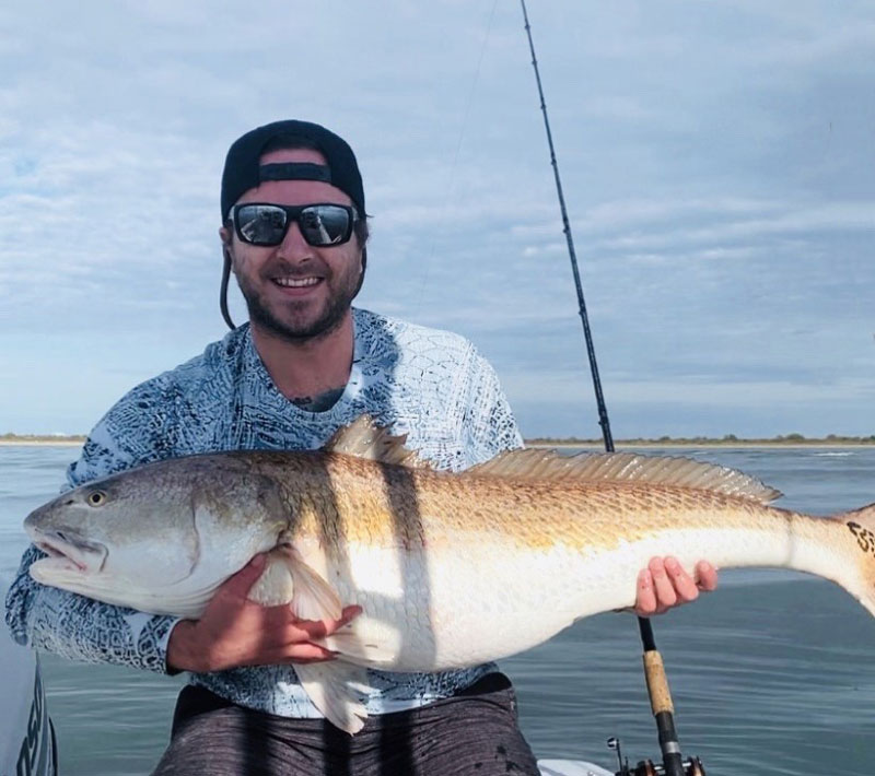 angler with a spring bull redfish in virginia