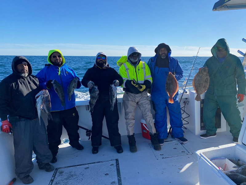 anglers with sea bass and flounder