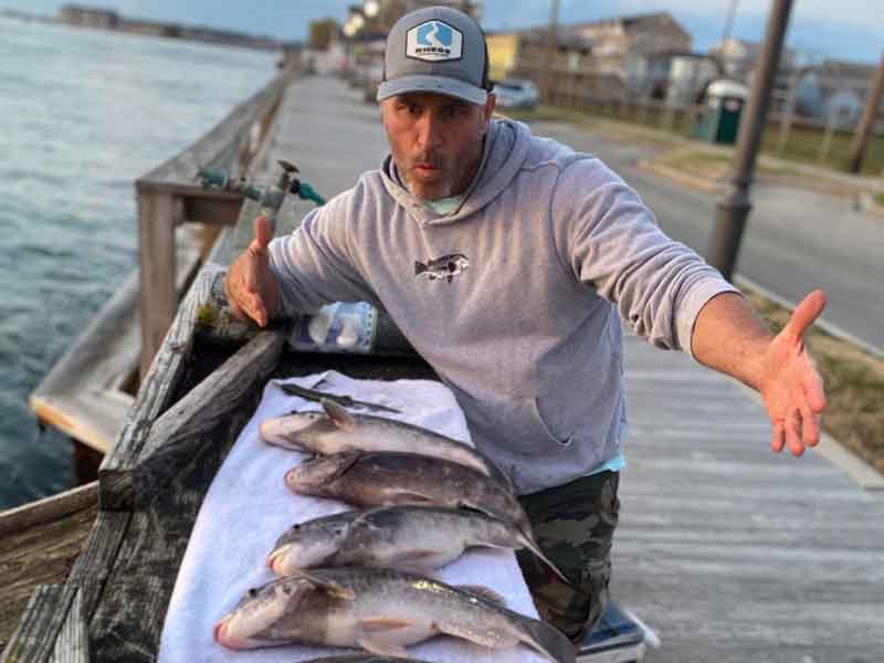 tautog angler with his catch
