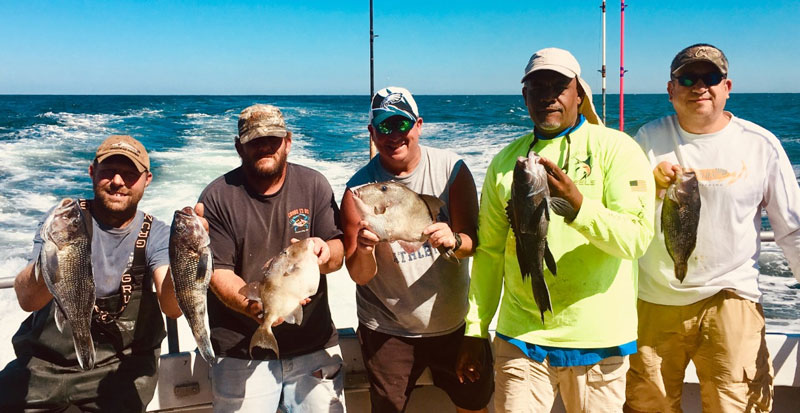 fishermen hold up the catch