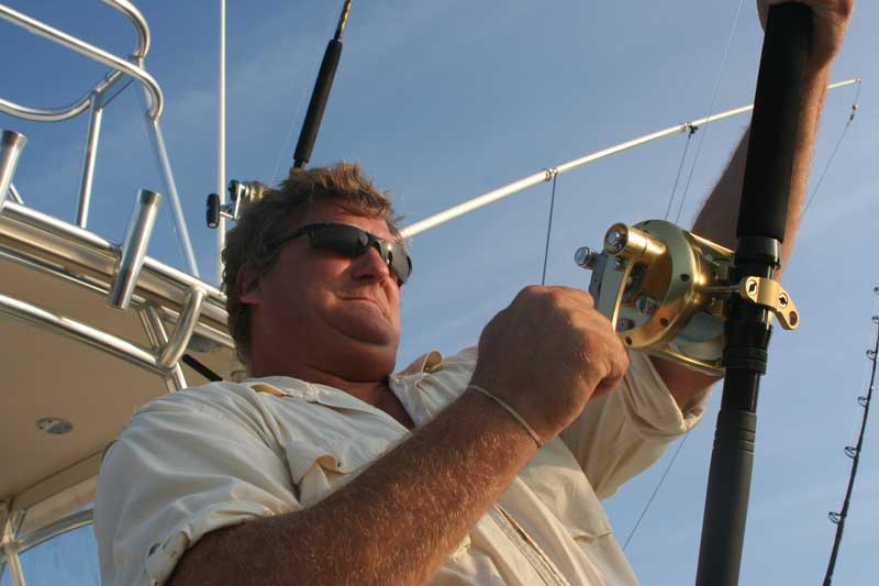 an angler using a conventional reel