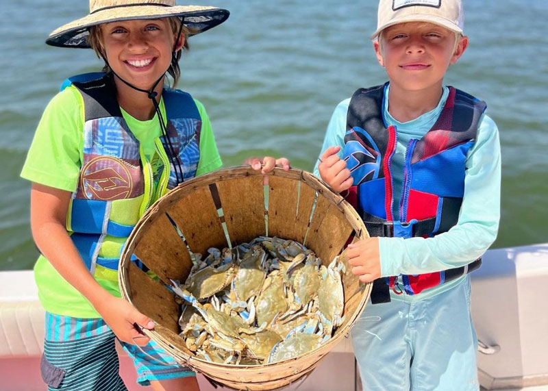 kids with a bushel of crabs they caught crabbing