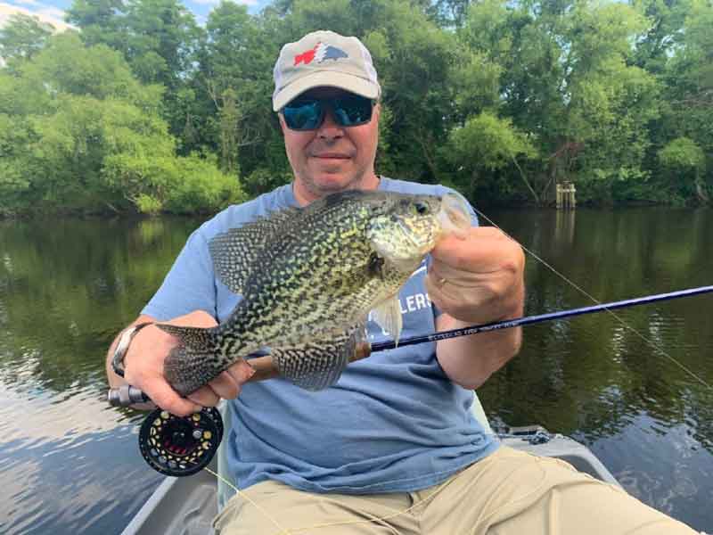 fly fisherman with his catch