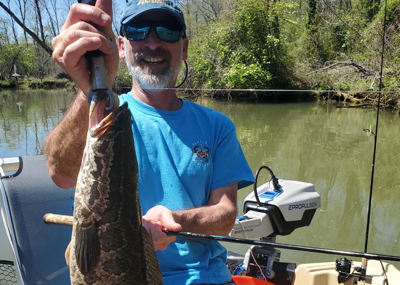angler fishing with an electric outboard on his boat