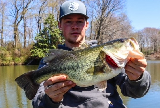 angler with a largemouth bass