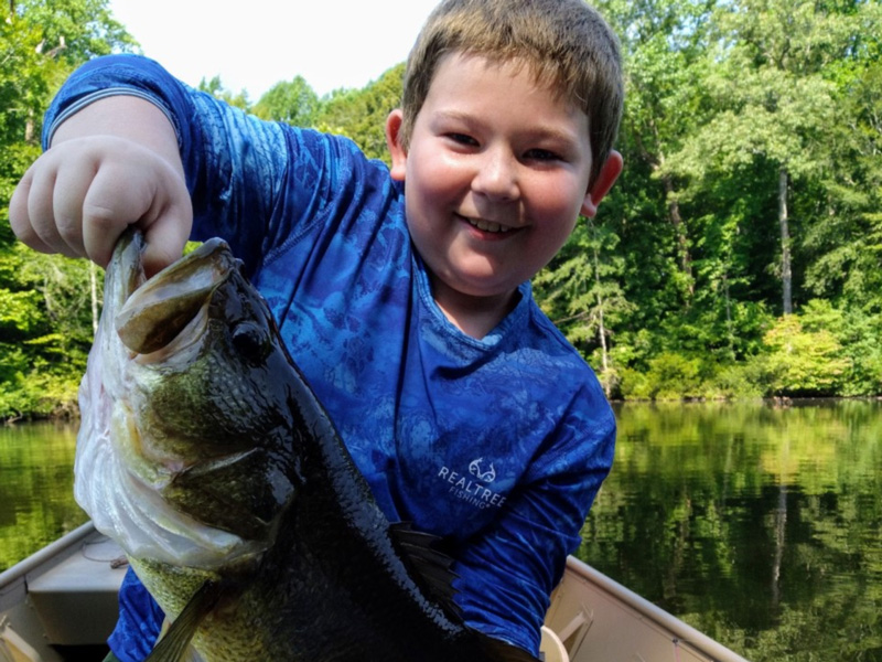 little boy with a big bass