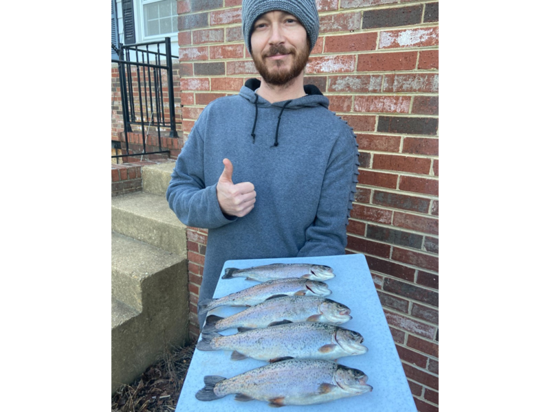 trout fisherman with a catch of stocked fish