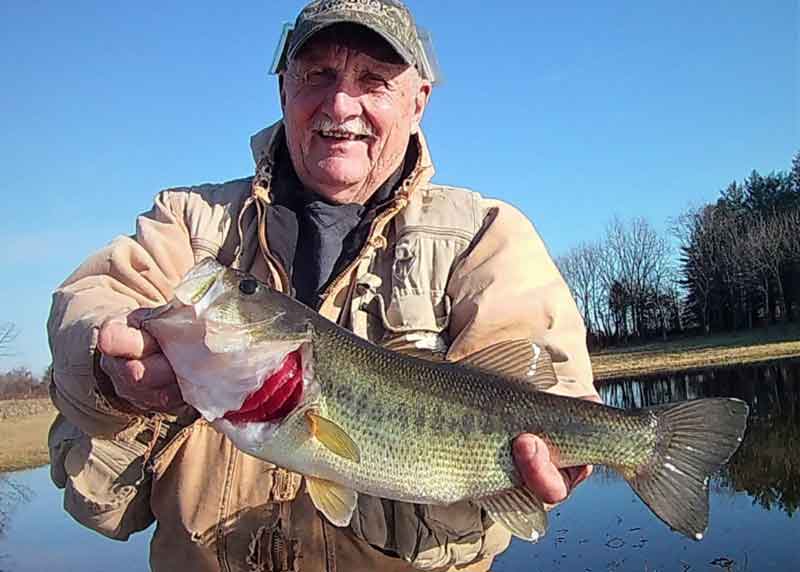 alvie holds up a big bass