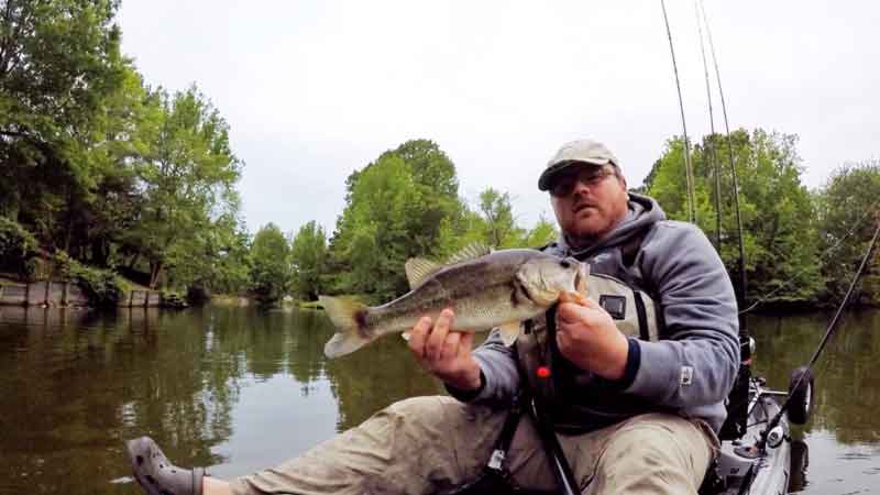 kayak angler with a bass