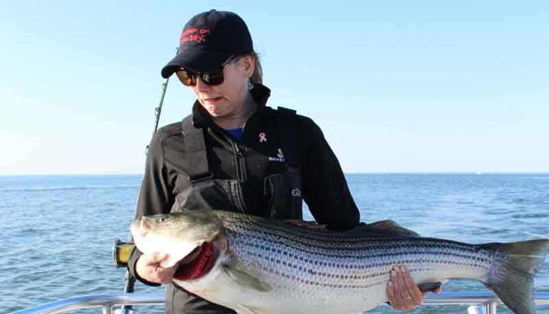 woman holding a fish but unhappy