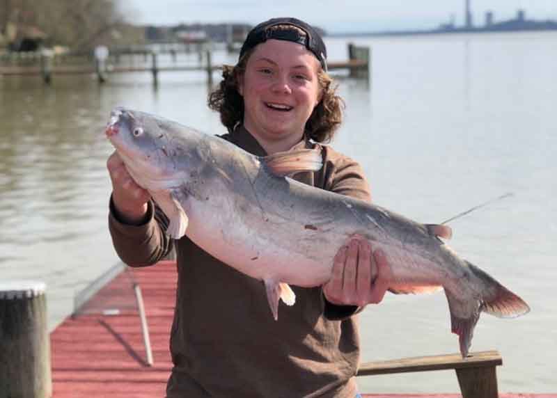 fisherman with his catfish