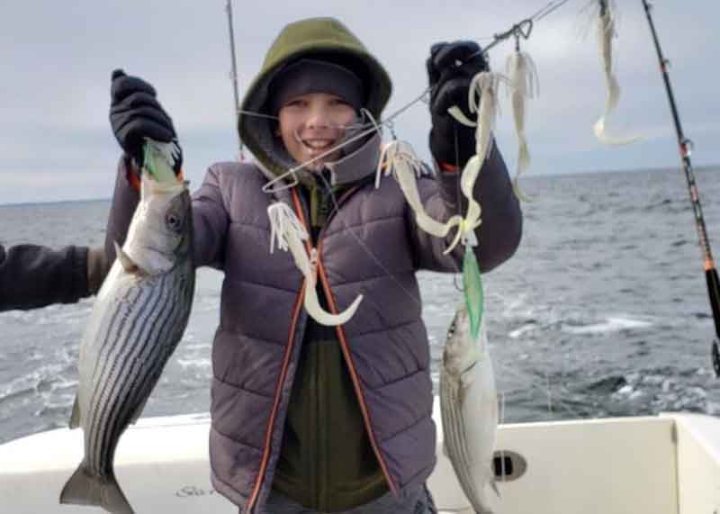 kid fishing for stripers in winter