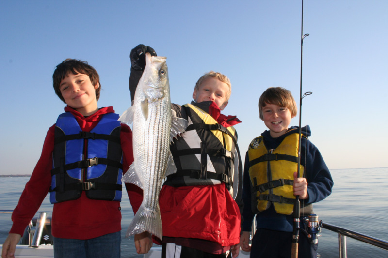 kids holding up rockfish