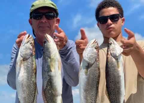 holding up speckled sea trout