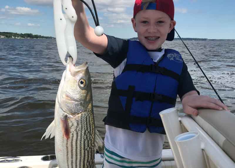 kid caught a rockfish in the bay