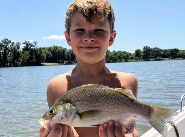 kid with a white perch he caught