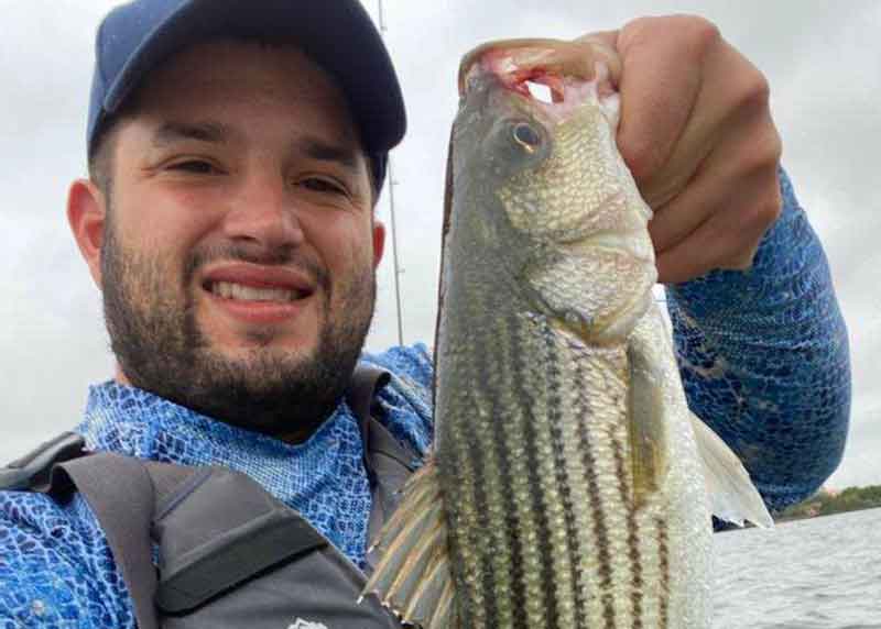 angler with an upper bay rockfish