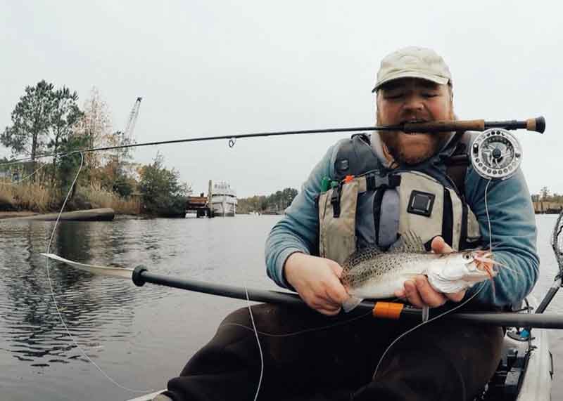 fly fisherman caught a speckled trout
