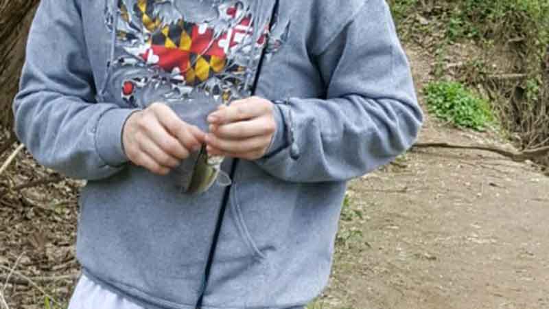 fisherman unhooking a fish